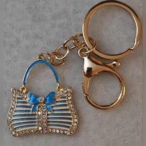 Bag Charm Gold With Blue Bow